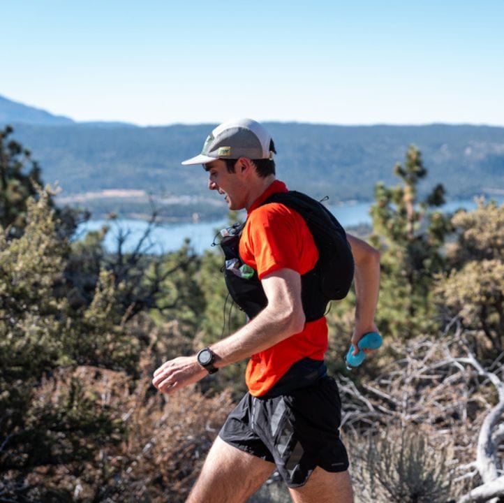 Man running at HOKA Kodiak by UTMB with several naak product